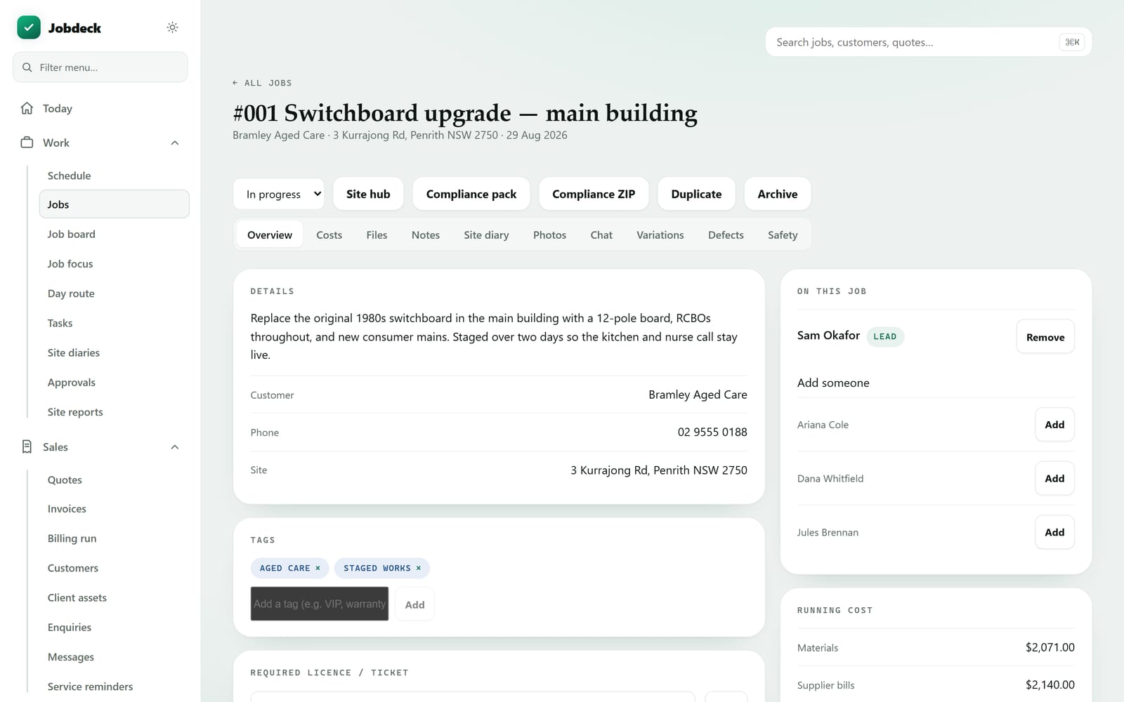 A Jobdeck job record with ten tabs across the top: overview, costs, files, notes, site diary, photos, chat, variations, defects and safety. The overview shows the customer, site address, who is on the job and the running cost.